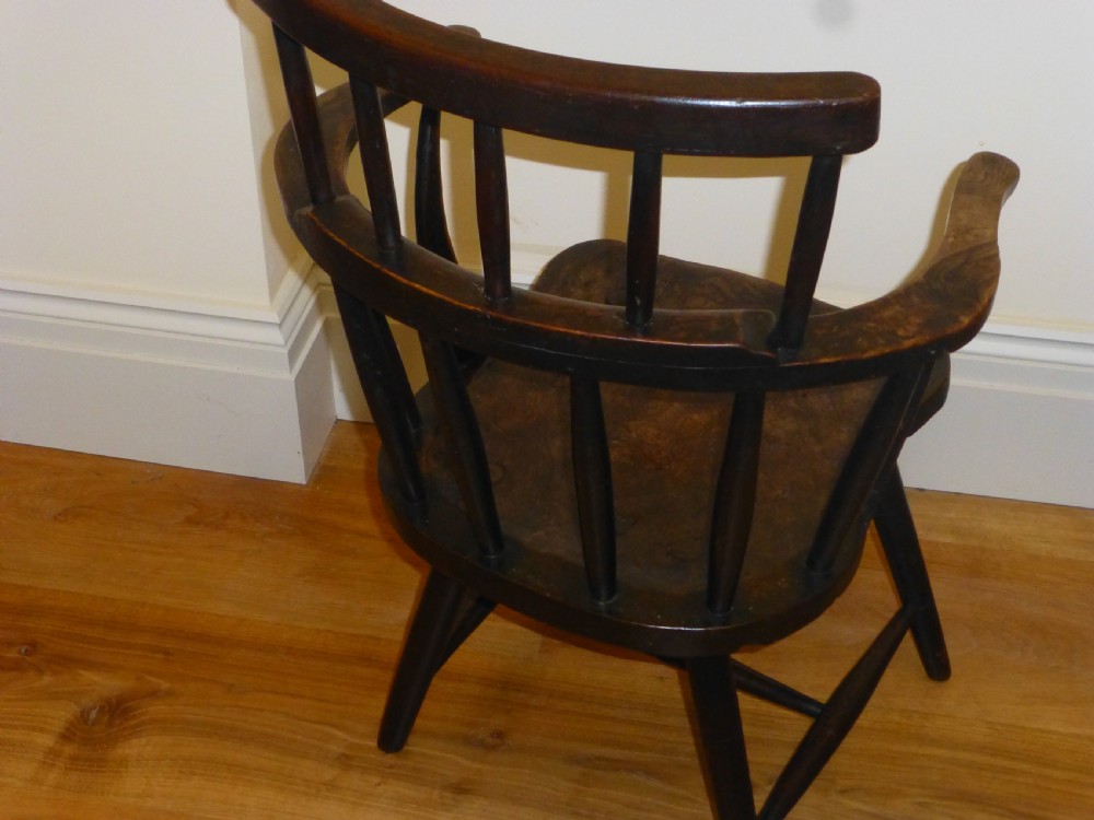 An 18th-century Welsh primitive stick Windsor armchair crafted from dark burr elm and ash with a comb back and turned legs. View VI