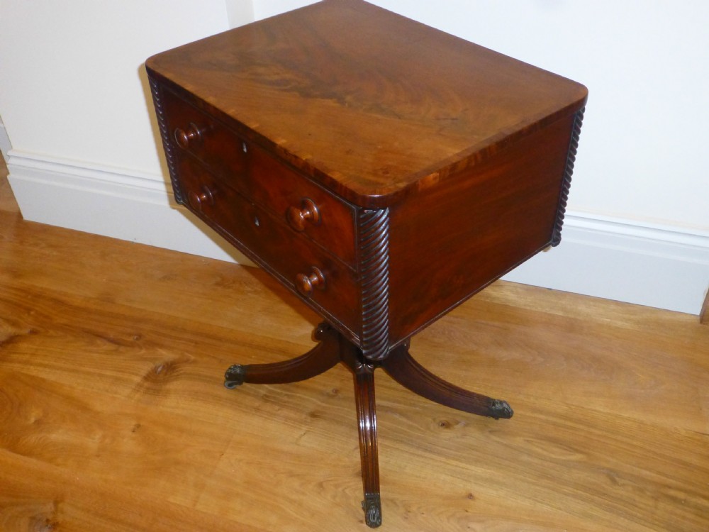 A Regency mahogany work table featuring two drawers with wooden knobs, spirally reeded side columns, and a turned pedestal base on quadruped sabre legs with brass castors. View II