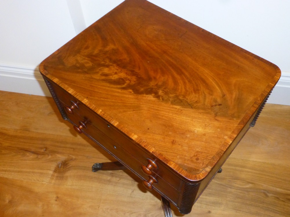 A Regency mahogany work table featuring two drawers with wooden knobs, spirally reeded side columns, and a turned pedestal base on quadruped sabre legs with brass castors. View III