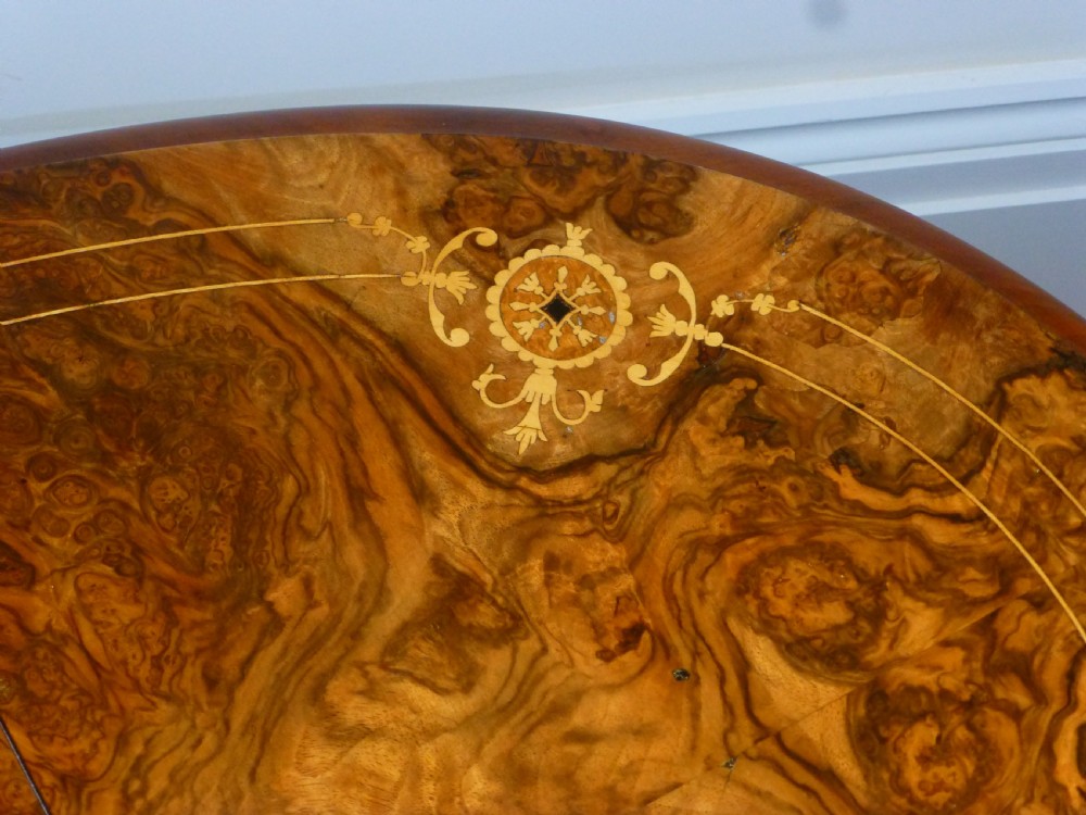 A 19th-century burr walnut Sutherland side table featuring drop leaves with floral marquetry inlay and turned legs on ceramic castors. View V