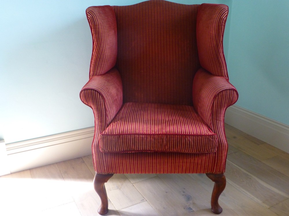 An 18th-century Georgian wingback armchair upholstered in red and gold striped fabric with carved cabriole front legs. View II