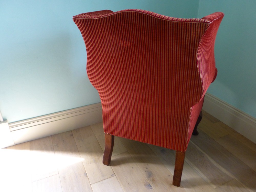 An 18th-century Georgian wingback armchair upholstered in red and gold striped fabric with carved cabriole front legs. View VII