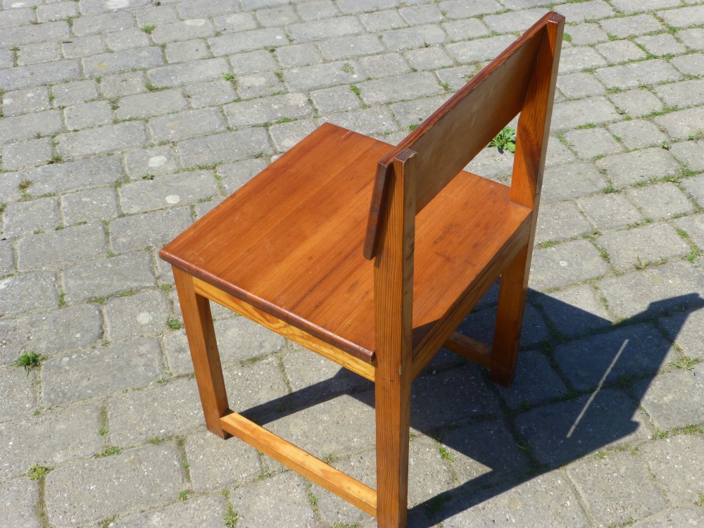 A set of six warm amber-toned solid pine dining chairs featuring flat rectangular backrests and solid square panel seats. View IV