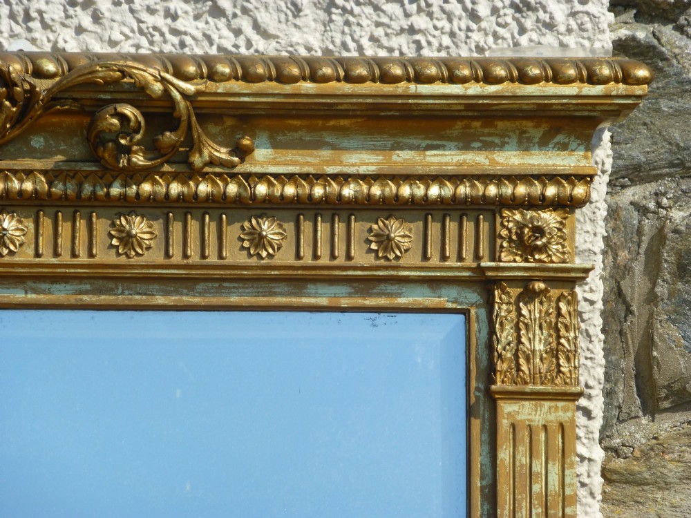 A large rectangular nineteenth-century gilt overmantel mirror featuring fluted pilasters, rosette corner embellishments, and a central leaf cresting. View III