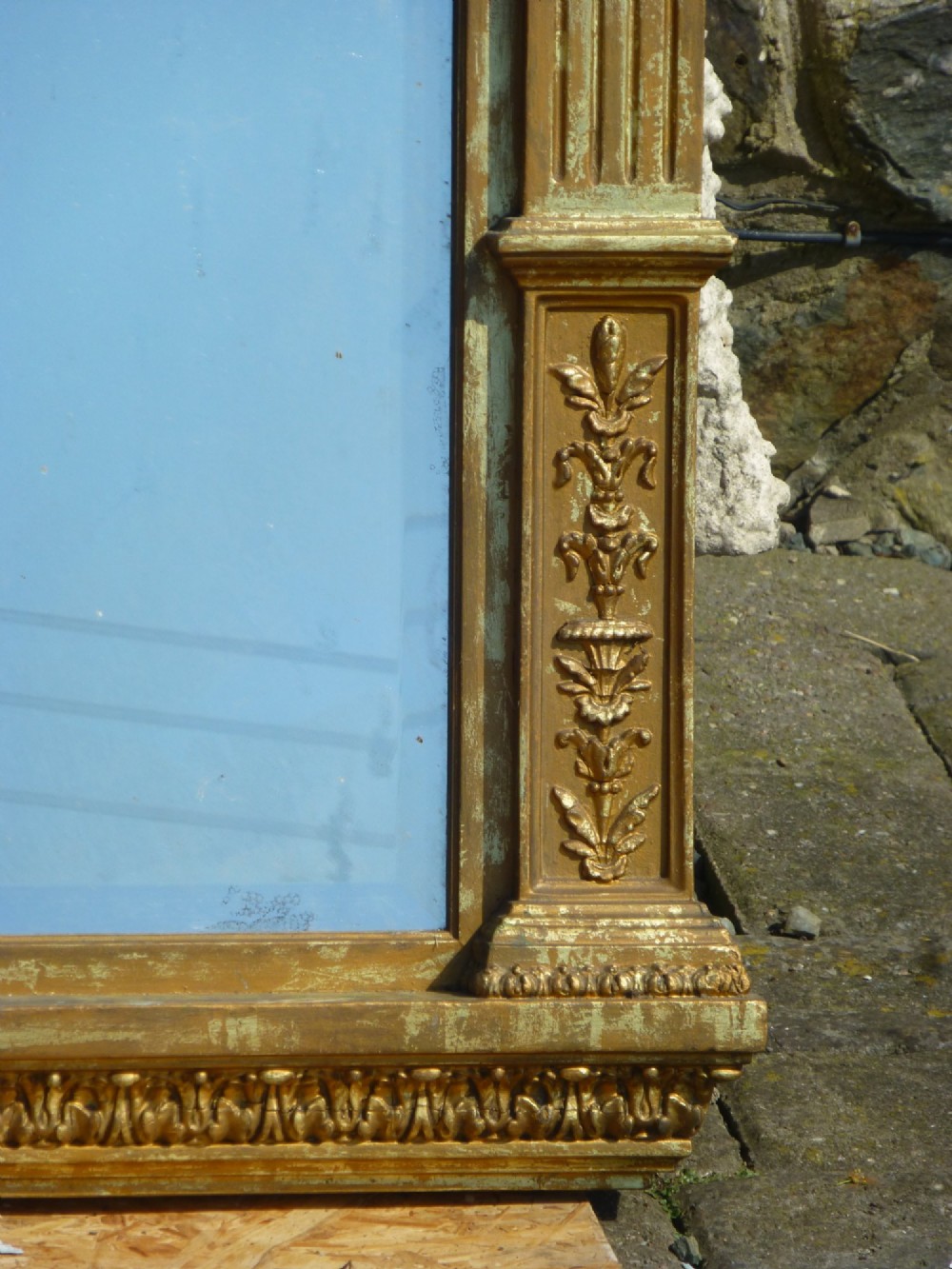 A large rectangular nineteenth-century gilt overmantel mirror featuring fluted pilasters, rosette corner embellishments, and a central leaf cresting. View IV