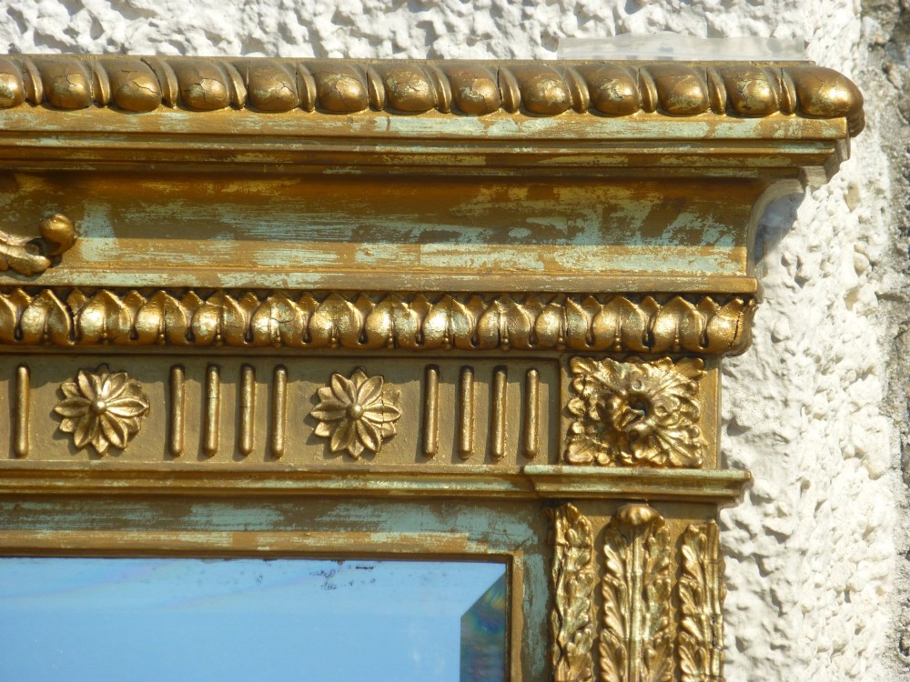 A large rectangular nineteenth-century gilt overmantel mirror featuring fluted pilasters, rosette corner embellishments, and a central leaf cresting. View V