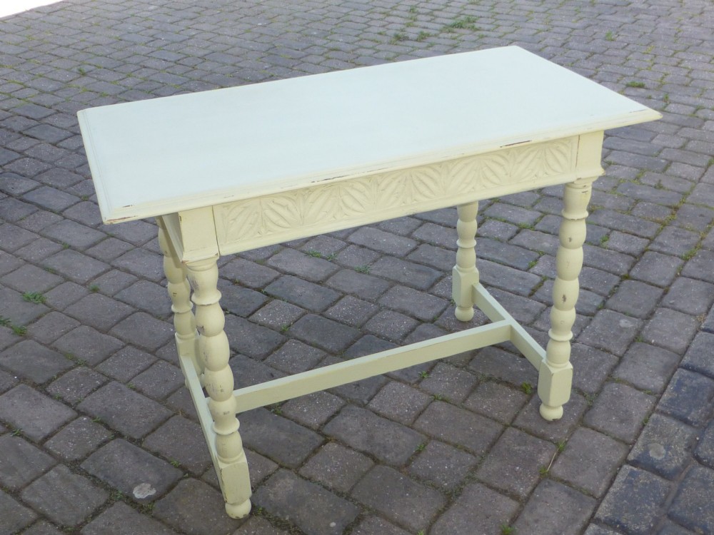 A late 19th-century cream-painted oak console table with a carved single drawer and turned legs connected by a low stretcher. View II