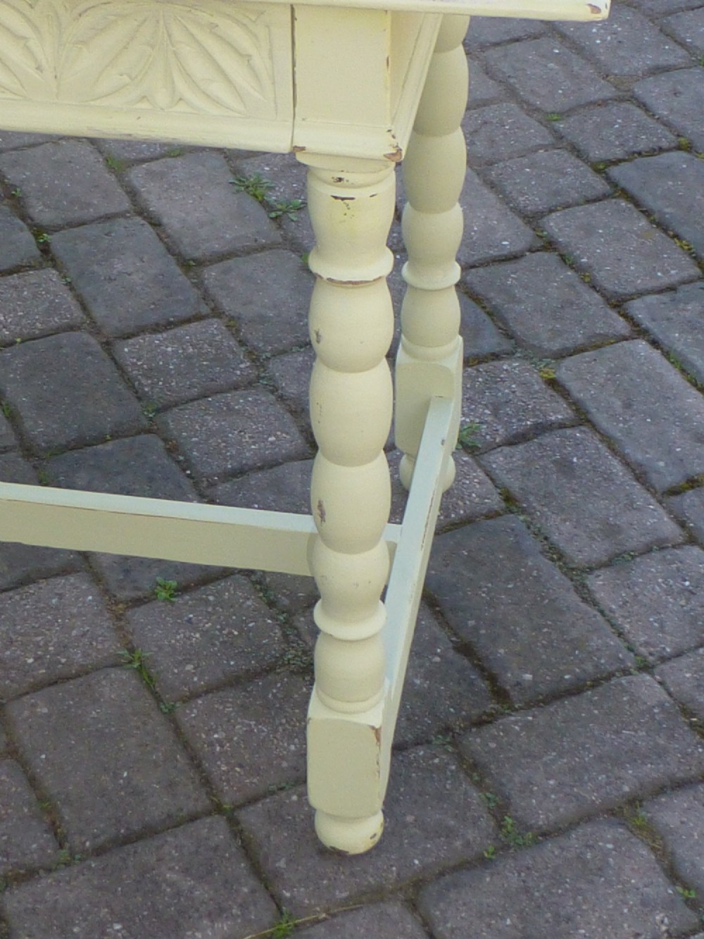 A late 19th-century cream-painted oak console table with a carved single drawer and turned legs connected by a low stretcher. View IV