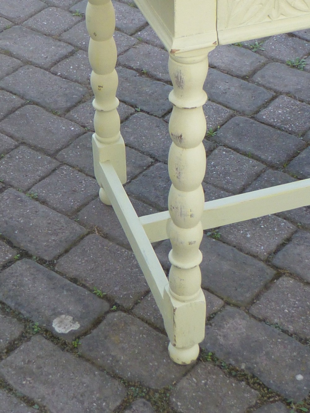 A late 19th-century cream-painted oak console table with a carved single drawer and turned legs connected by a low stretcher. View V