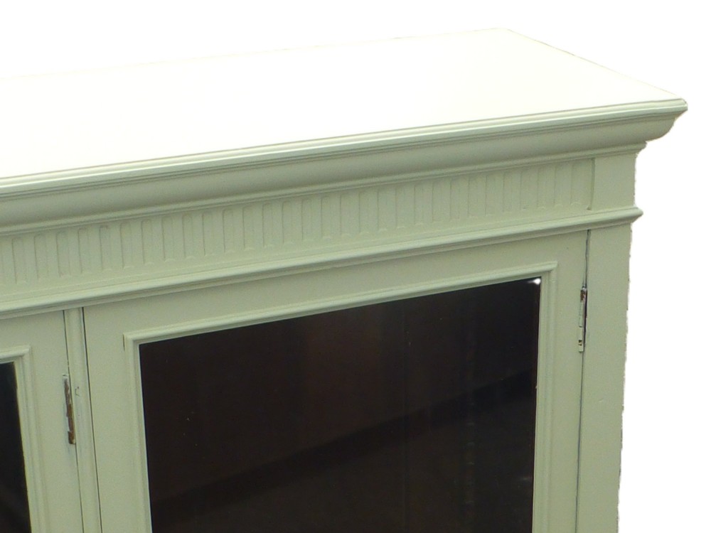 A 19th-century off-white painted bookcase featuring three glazed glass doors, fluted side pilasters, and a contrasting dark interior. View IV