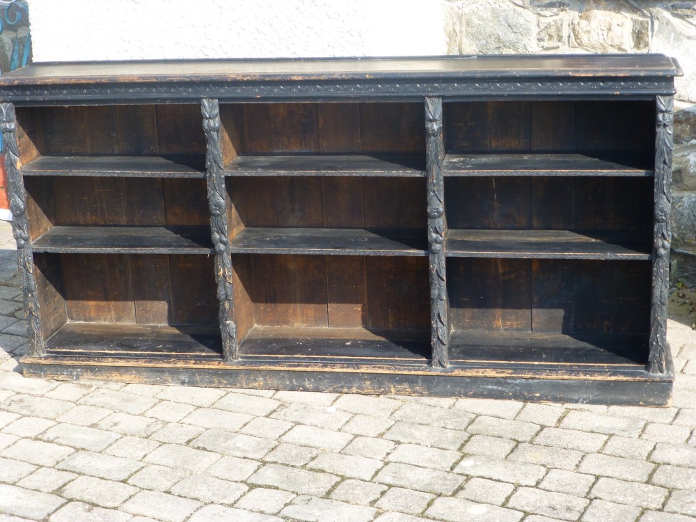 ebonised carved green man low open dwarf bookcase with adjustable shelves