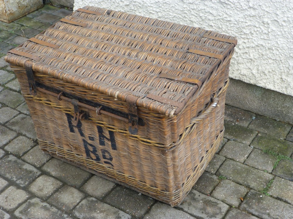 A large 19th-century woven brown wicker travelling trunk with iron latches and stencilled black lettering on the front. View II
