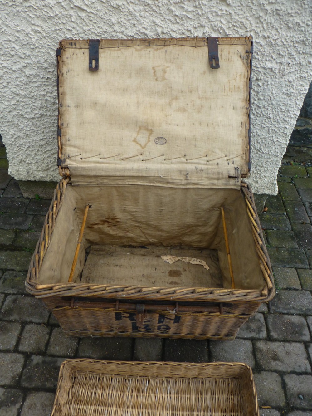 A large 19th-century woven brown wicker travelling trunk with iron latches and stencilled black lettering on the front. View III