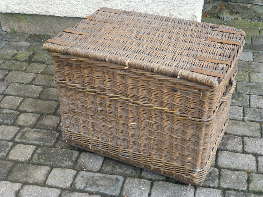 A large 19th-century woven brown wicker travelling trunk with iron latches and stencilled black lettering on the front. View VI