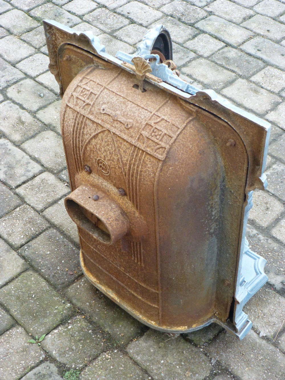 A French Art Nouveau slate blue enamelled cast iron log burner stove adorned with floral relief mouldings and an arched windowed door. View VI