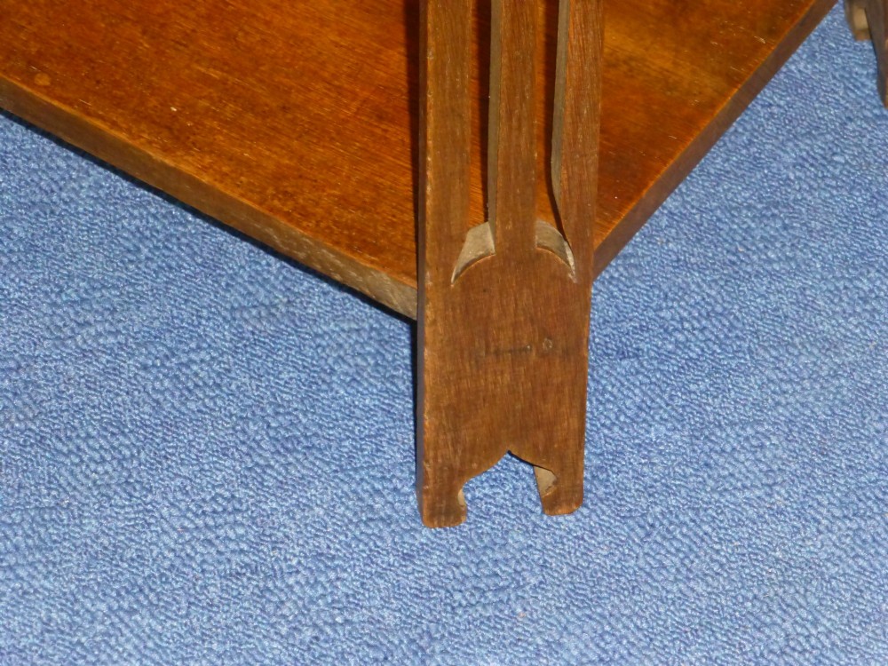 An Arts and Crafts solid oak occasional table featuring a square top with fine chequered inlay, a lower shelf, and vertical leg supports with heart-shaped cutouts. View III