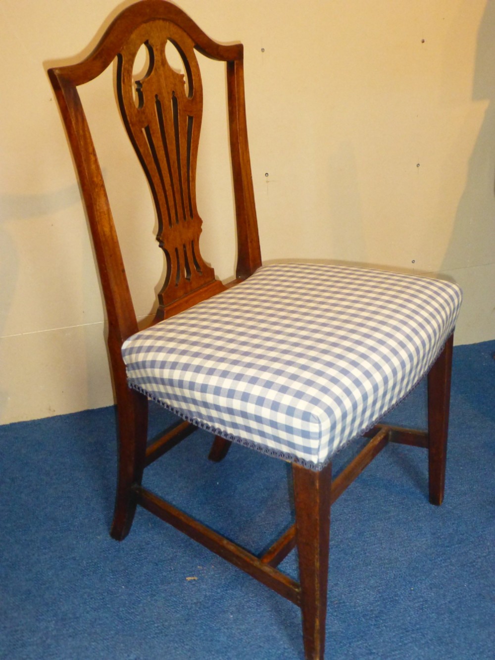 An 18th-century Georgian Chippendale side chair featuring a carved pierced splat back, warm fruitwood frame, and a blue and white checked upholstered seat. View II
