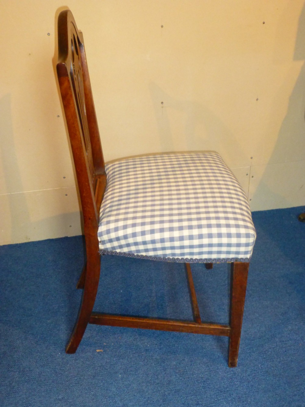 An 18th-century Georgian Chippendale side chair featuring a carved pierced splat back, warm fruitwood frame, and a blue and white checked upholstered seat. View III