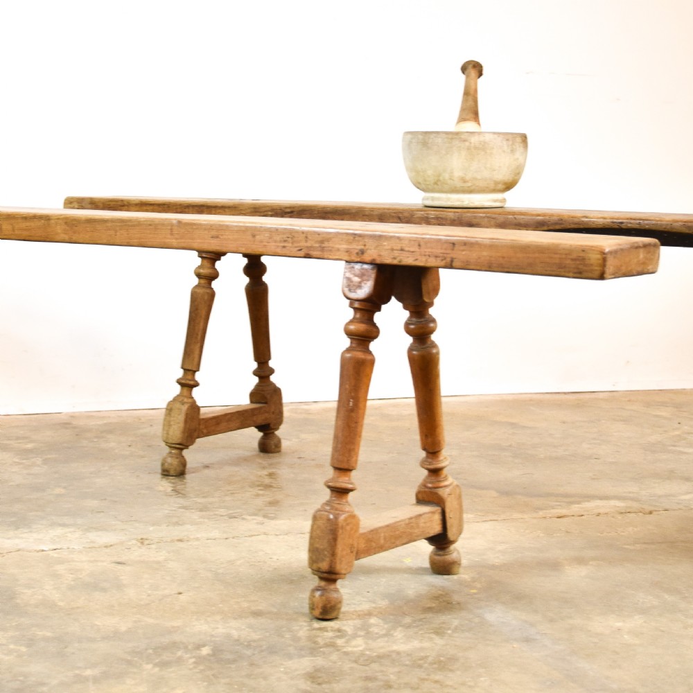 A pair of long French cherrywood benches featuring narrow plank seats and turned legs connected by low stretchers. View II