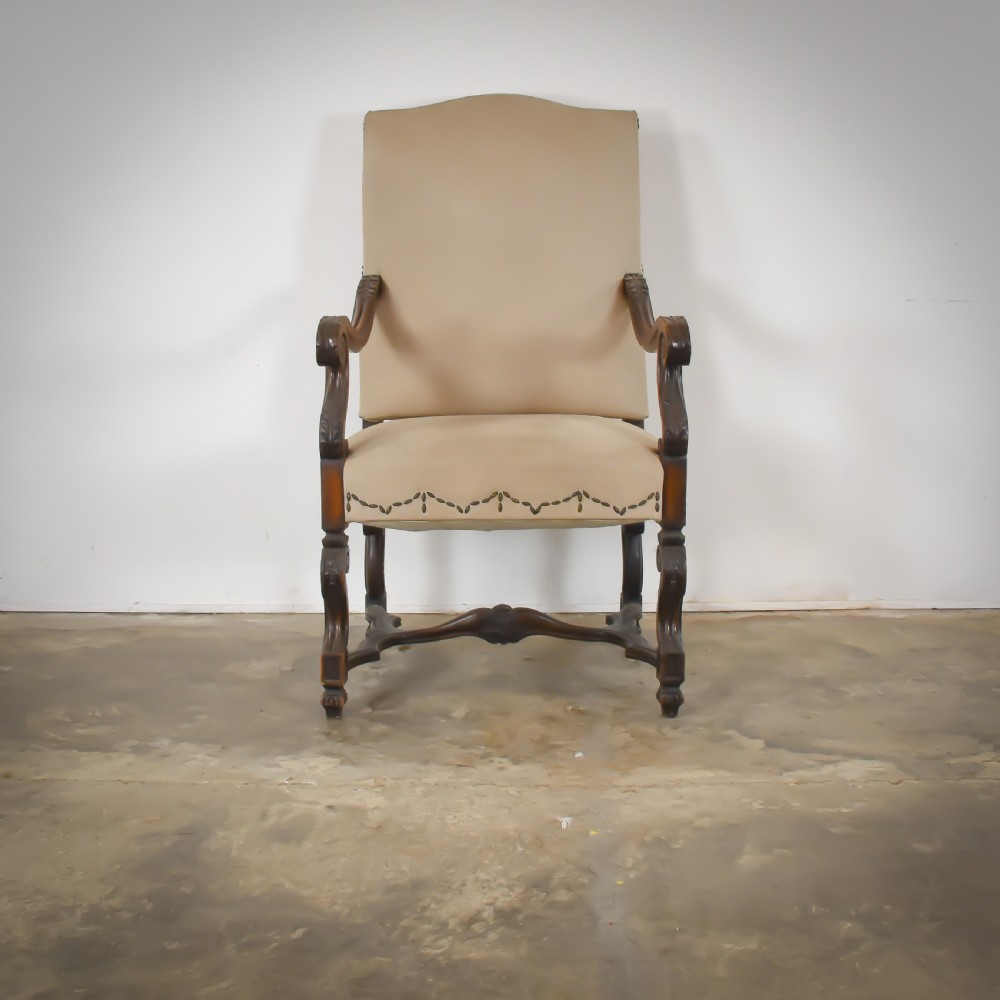 A late 19th-century French Os de Mouton armchair featuring carved timber scroll arms, serpentine stretchers, neutral fabric upholstery, and decorative stud detail. View II