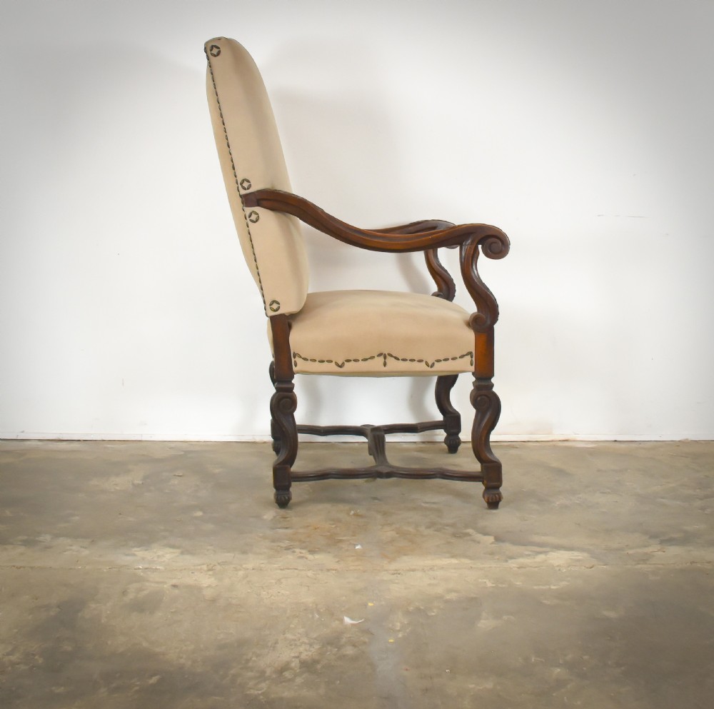 A late 19th-century French Os de Mouton armchair featuring carved timber scroll arms, serpentine stretchers, neutral fabric upholstery, and decorative stud detail. View III