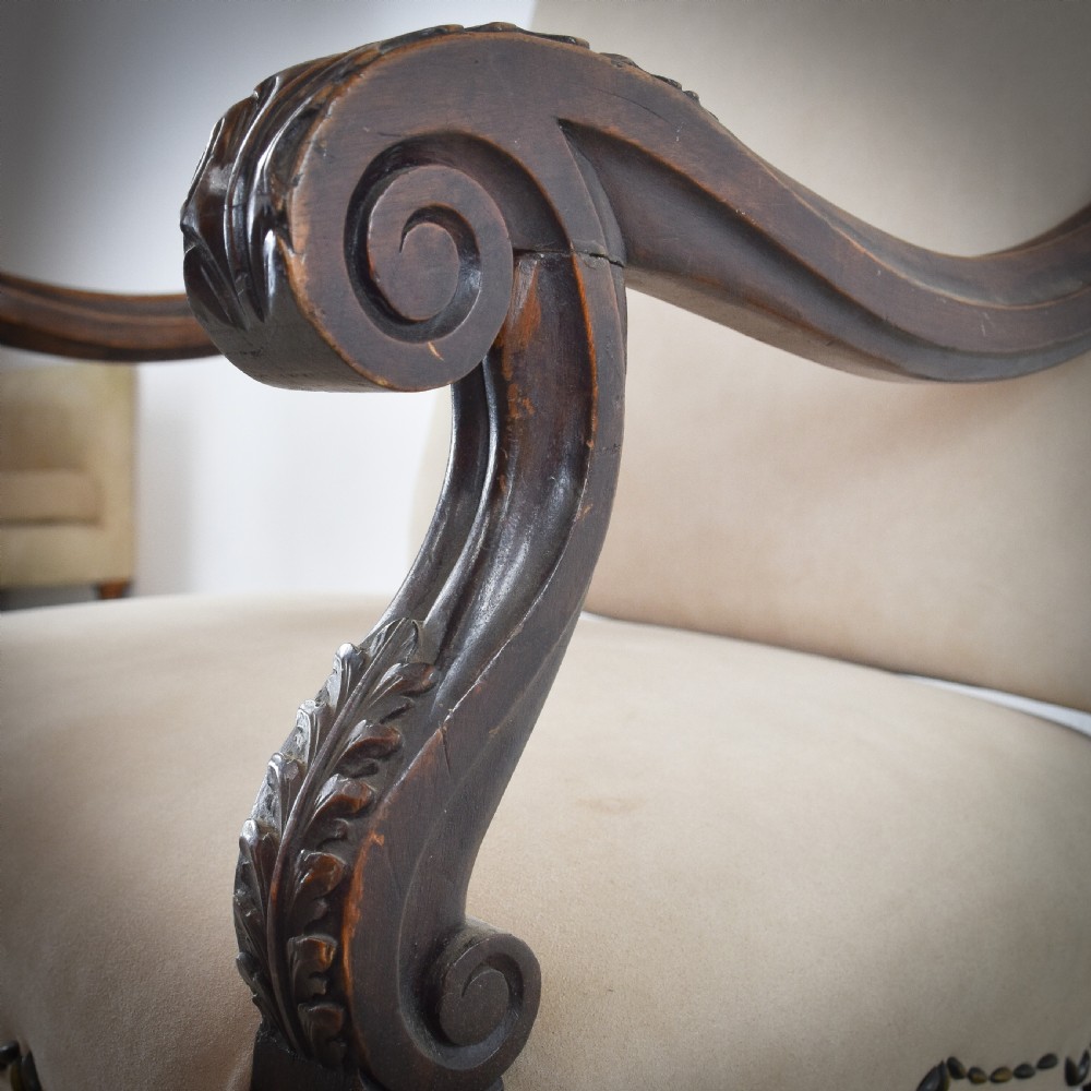 A late 19th-century French Os de Mouton armchair featuring carved timber scroll arms, serpentine stretchers, neutral fabric upholstery, and decorative stud detail. View IV