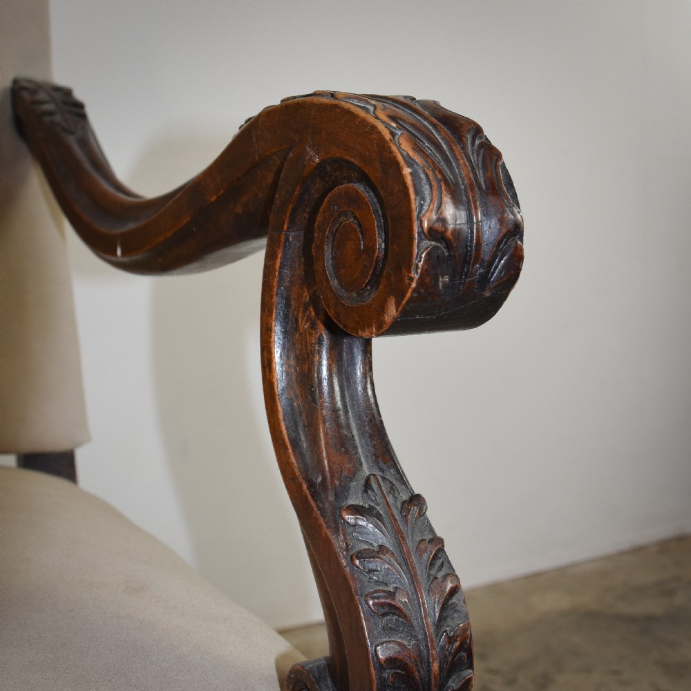 A late 19th-century French Os de Mouton armchair featuring carved timber scroll arms, serpentine stretchers, neutral fabric upholstery, and decorative stud detail. View V