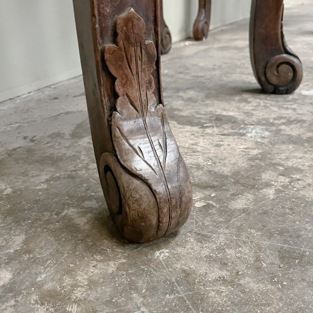 A pair of warm brown semicircular wooden console tables with carved aprons and outward-curved cabriole legs. View IV