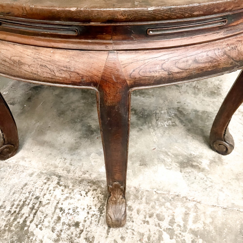 A pair of warm brown semicircular wooden console tables with carved aprons and outward-curved cabriole legs. View V