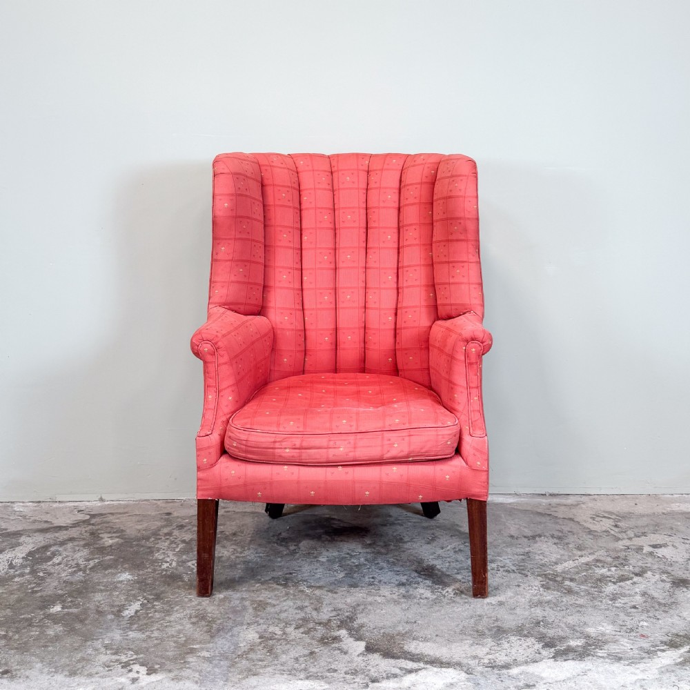A red patterned upholstered barrel back armchair featuring vertical channel stitching, a fitted seat cushion, and dark wooden legs. View II