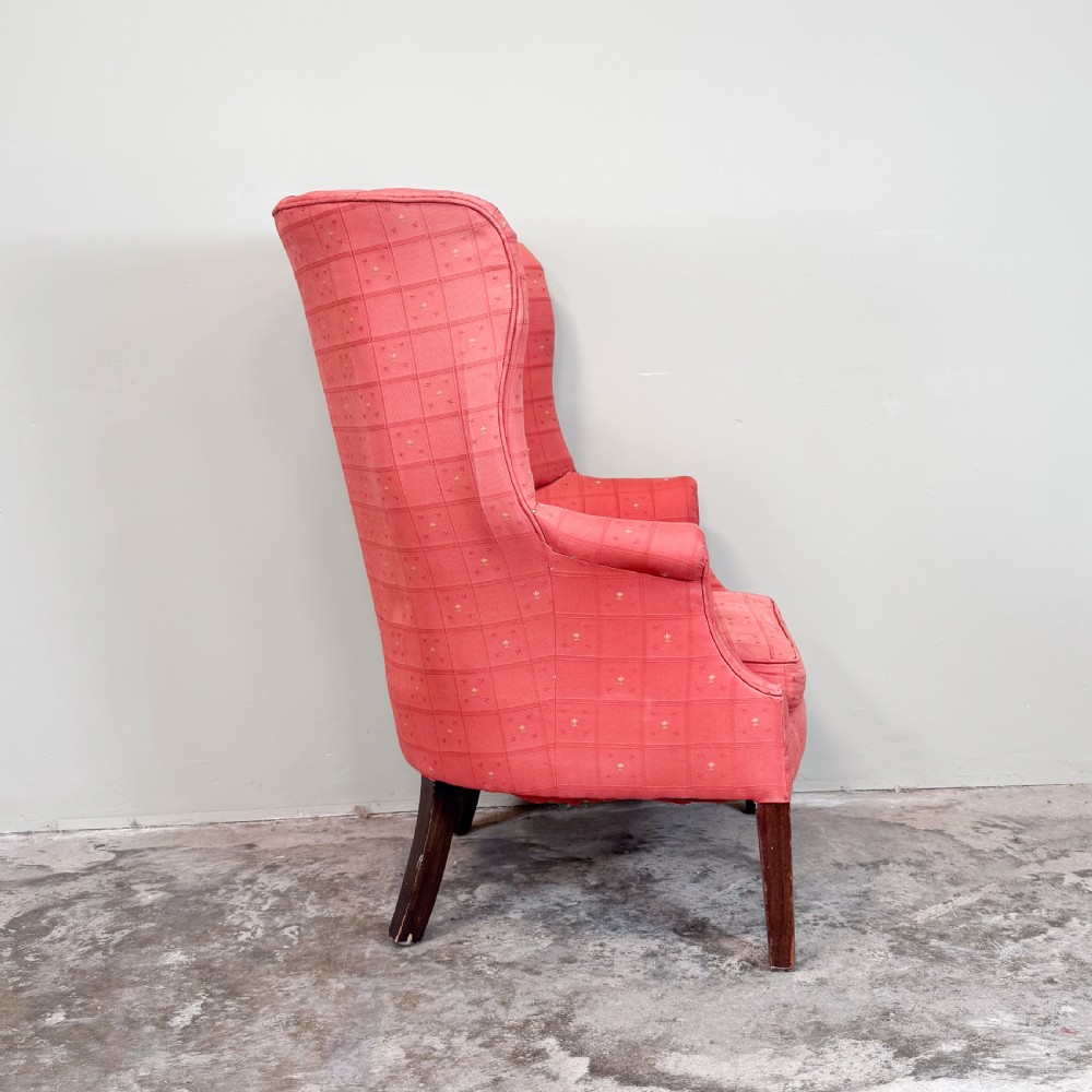 A red patterned upholstered barrel back armchair featuring vertical channel stitching, a fitted seat cushion, and dark wooden legs. View III