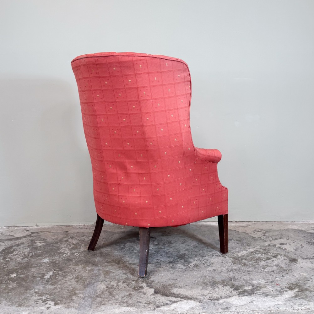 A red patterned upholstered barrel back armchair featuring vertical channel stitching, a fitted seat cushion, and dark wooden legs. View IV