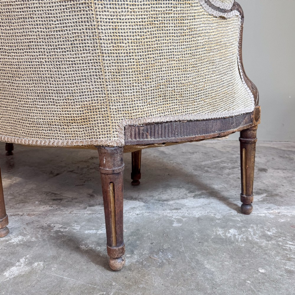 A mid-19th century French canape featuring a carved wooden frame with fluted legs and warm beige upholstery. View VI