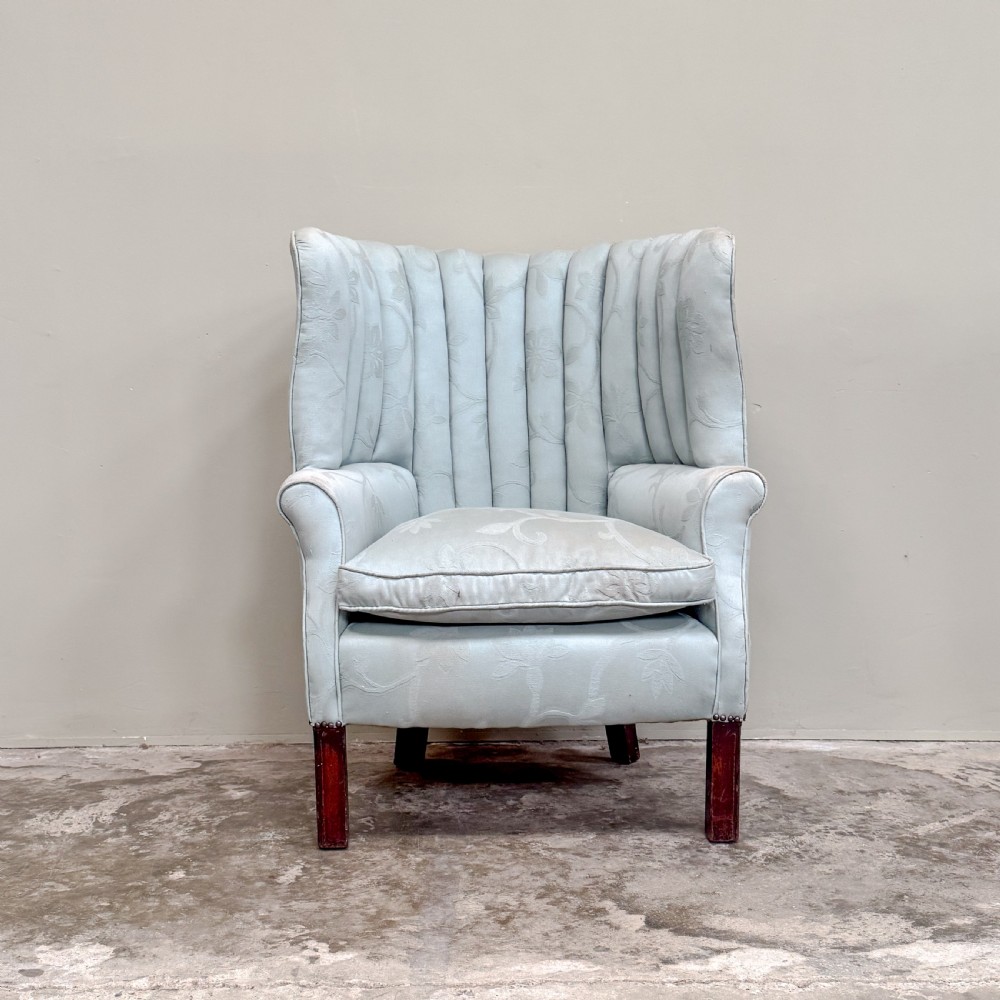 A light blue 1920s ribbed barrel back armchair with floral fabric upholstery and square dark wood legs. View II