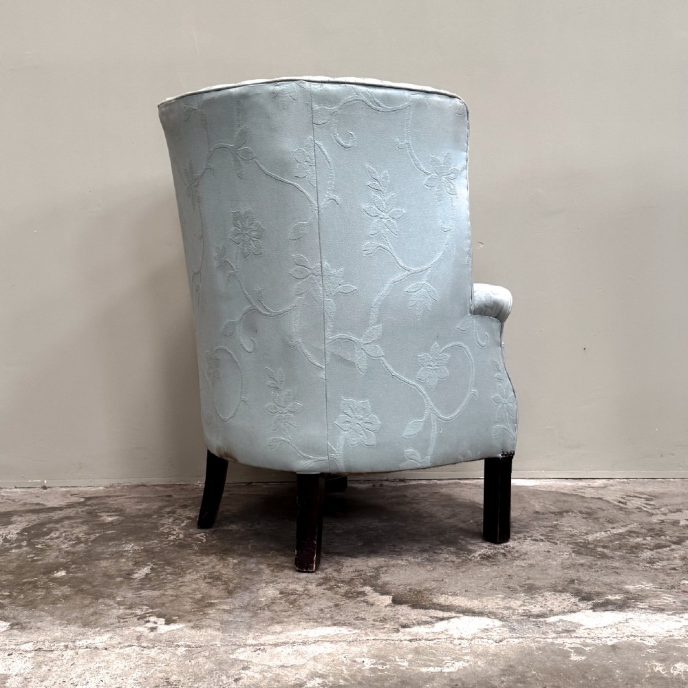A light blue 1920s ribbed barrel back armchair with floral fabric upholstery and square dark wood legs. View IV