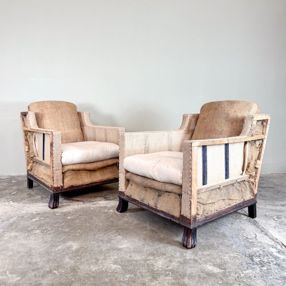 A pair of 1920s French armchairs upholstered in beige hessian with white seat cushions, stud trim, and carved dark wooden legs. View III