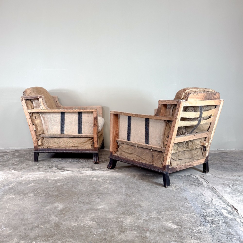 A pair of 1920s French armchairs upholstered in beige hessian with white seat cushions, stud trim, and carved dark wooden legs. View IV