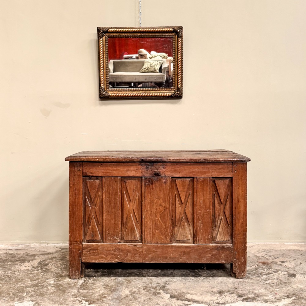 An 18th-century French provincial wooden coffer featuring hand-carved geometric front panels and a hinged top lid. View II
