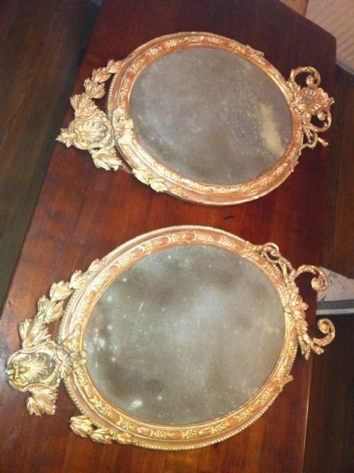 Pair of Early 19th Century French Oval  Distressed Wall Mirrors.