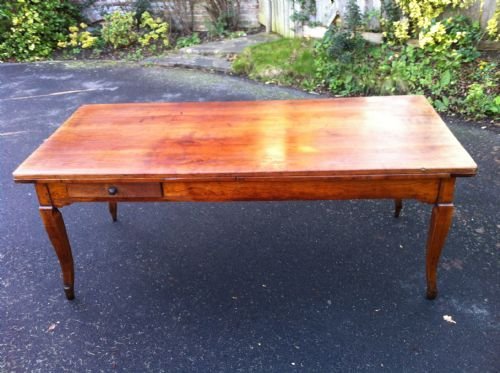 An Early 19th Century French Cherry Wood Dining with Drawer.
