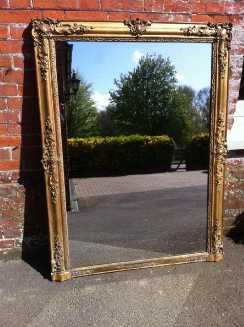 An Early 19th Century French Carved Wood Gilt and Gesso Louis Phillippe Wall Mirror.