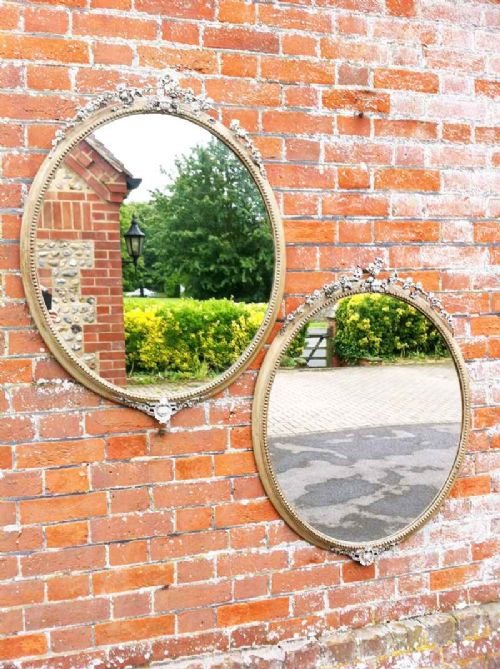 A Highly Unusual Pair of 19th Century French Decorative Carved Wood and Gesso Oval Mirrors