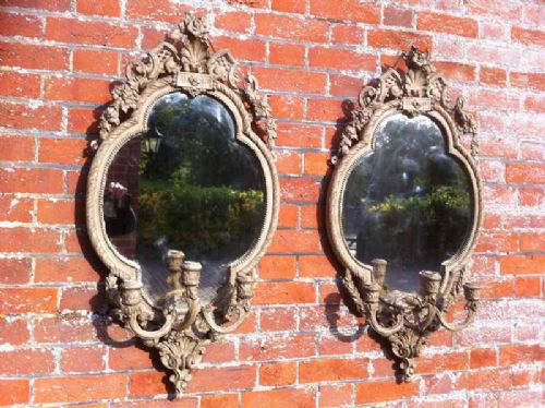 A Stunning Pair of Early 19th Century Carved Wood and Gesso Oval Mirrors.
