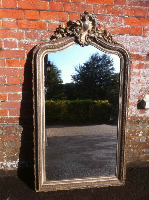 A Highly Decorative Early Large 19th Century French Cream Gilt and Silvered Carved Wood and Gesso Arched Top Mirror.