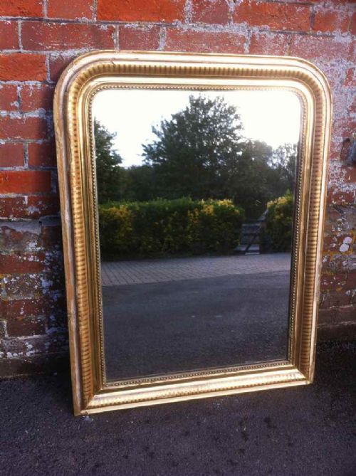 A 19th Centrury French Gilt and Ribbed Arched Top Mirror.