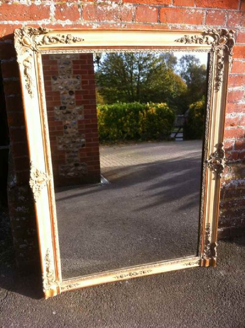 An Early 19th Century Cream and Gilt Carved Wood and Gesso Wall Mirror