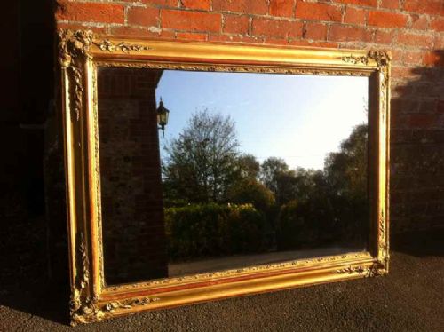A Large Early 19th Century French Carved Wood & Gesso Gilt and Red Mirror.