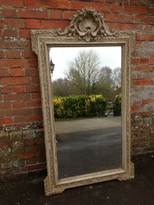 A Large Highly Decorative Antique French Carved Wood Painted Mirror with Ornate Crest Above.