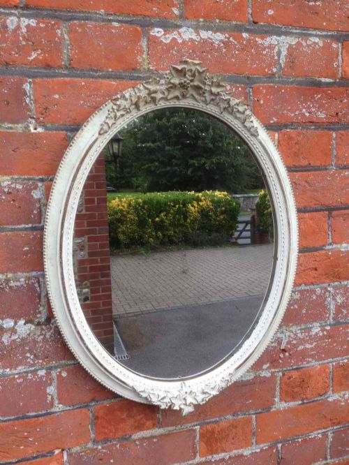 A Pair of Highly Useful Antique 19th Century French Carved Wood Oval Mirrors.