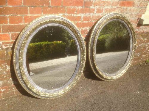 A Fabulous Pair of Antique 19th Century French Carved Wood Gilt and Painted Oval Mirrors.